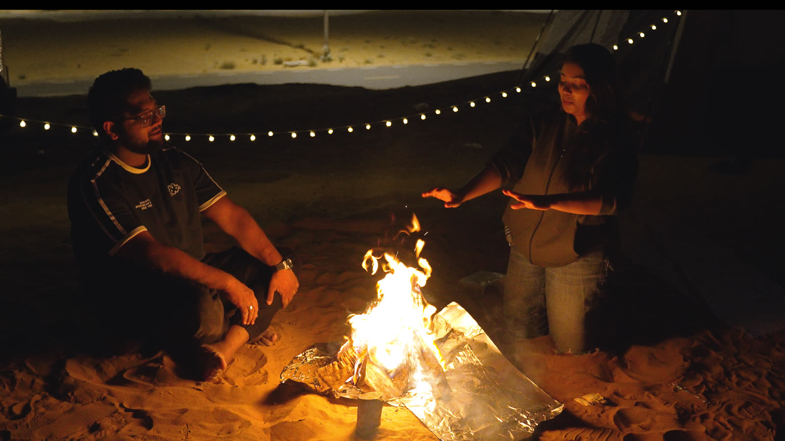 Vibha and Jishnu by the campfire